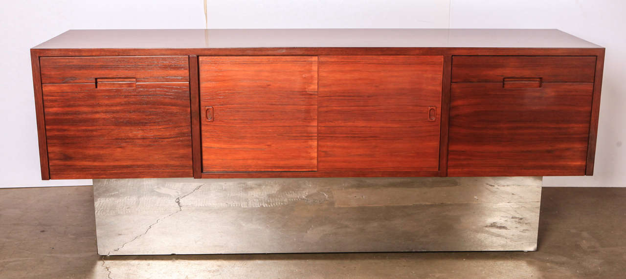 Simple, attractive mid-century credenza in walnut and chrome.